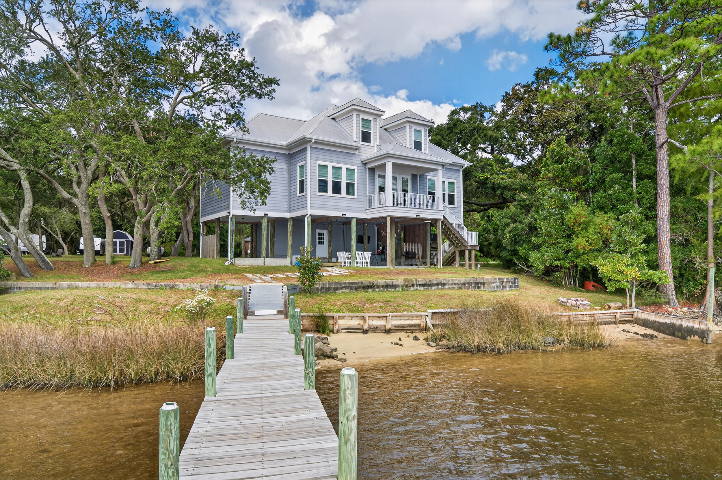 2975 Holley Point Road Navarre, FL 32566 - Photo 4 of 101 a front view of a house with swimming pool