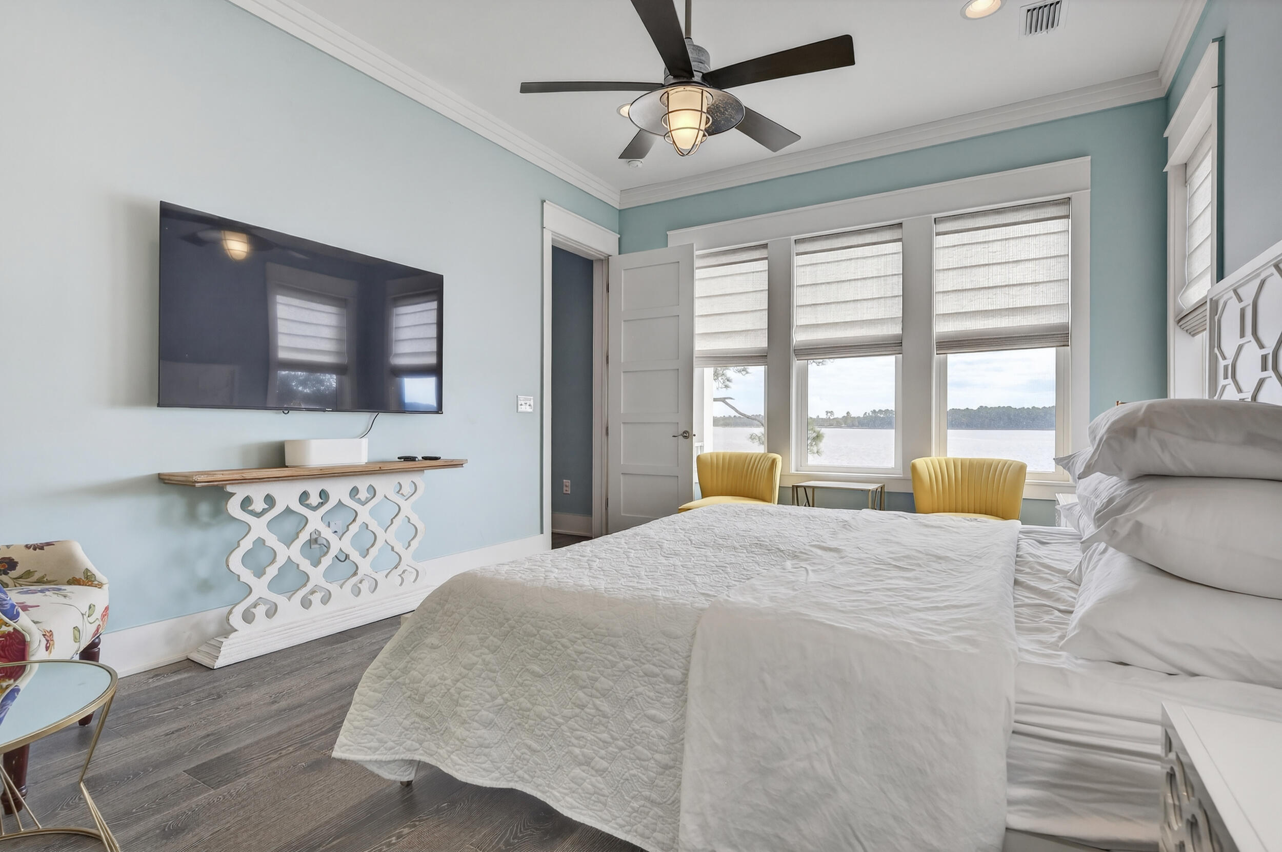 2975 Holley Point Road Navarre, FL 32566 - Photo 45 of 101 a bedroom with a large bed and a chandelier