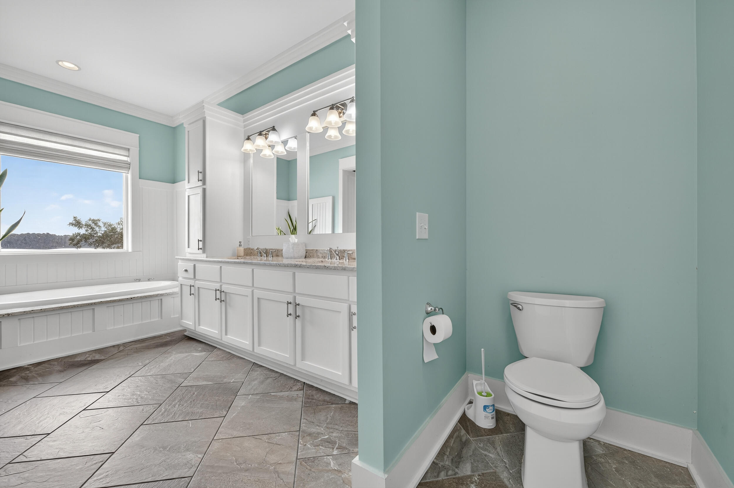 2975 Holley Point Road Navarre, FL 32566 - Photo 53 of 101 a bathroom with a toilet a sink and bathtub