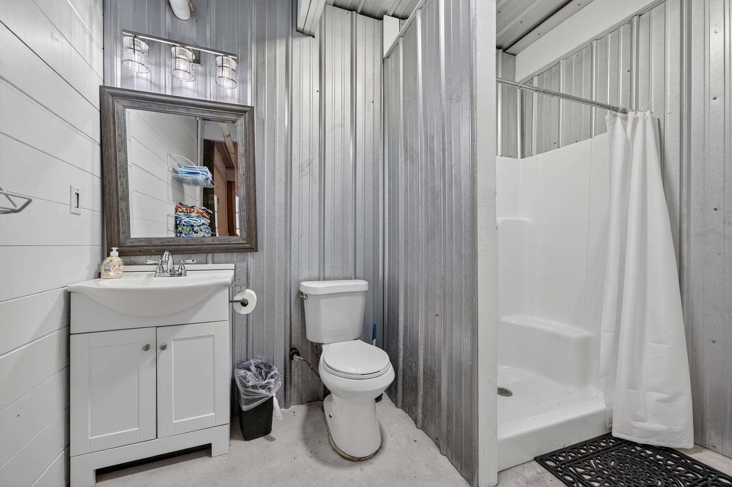 2975 Holley Point Road Navarre, FL 32566 - Photo 76 of 101 a bathroom with a toilet sink and shower