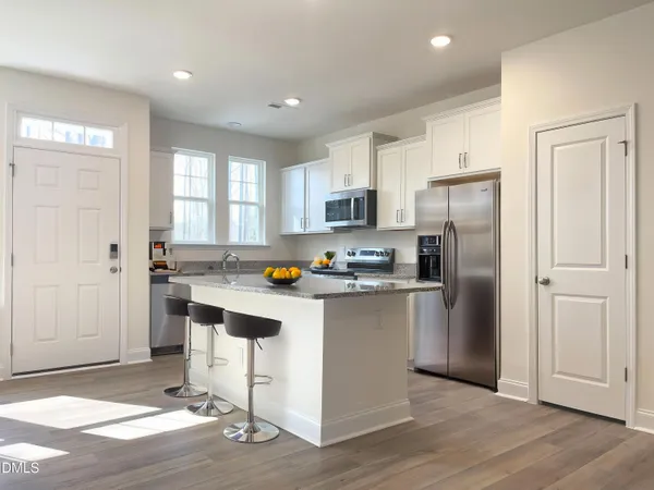 a kitchen with stainless steel appliances a refrigerator stove microwave and sink