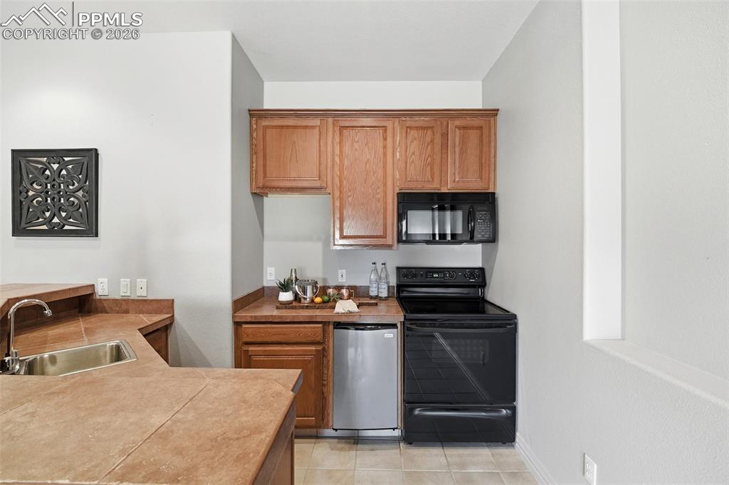 10350 Hodgen Road Colorado Springs, CO 80908 - Photo 25 of 49 Basement Kitchen with Dishwasher & Full Range/Oven