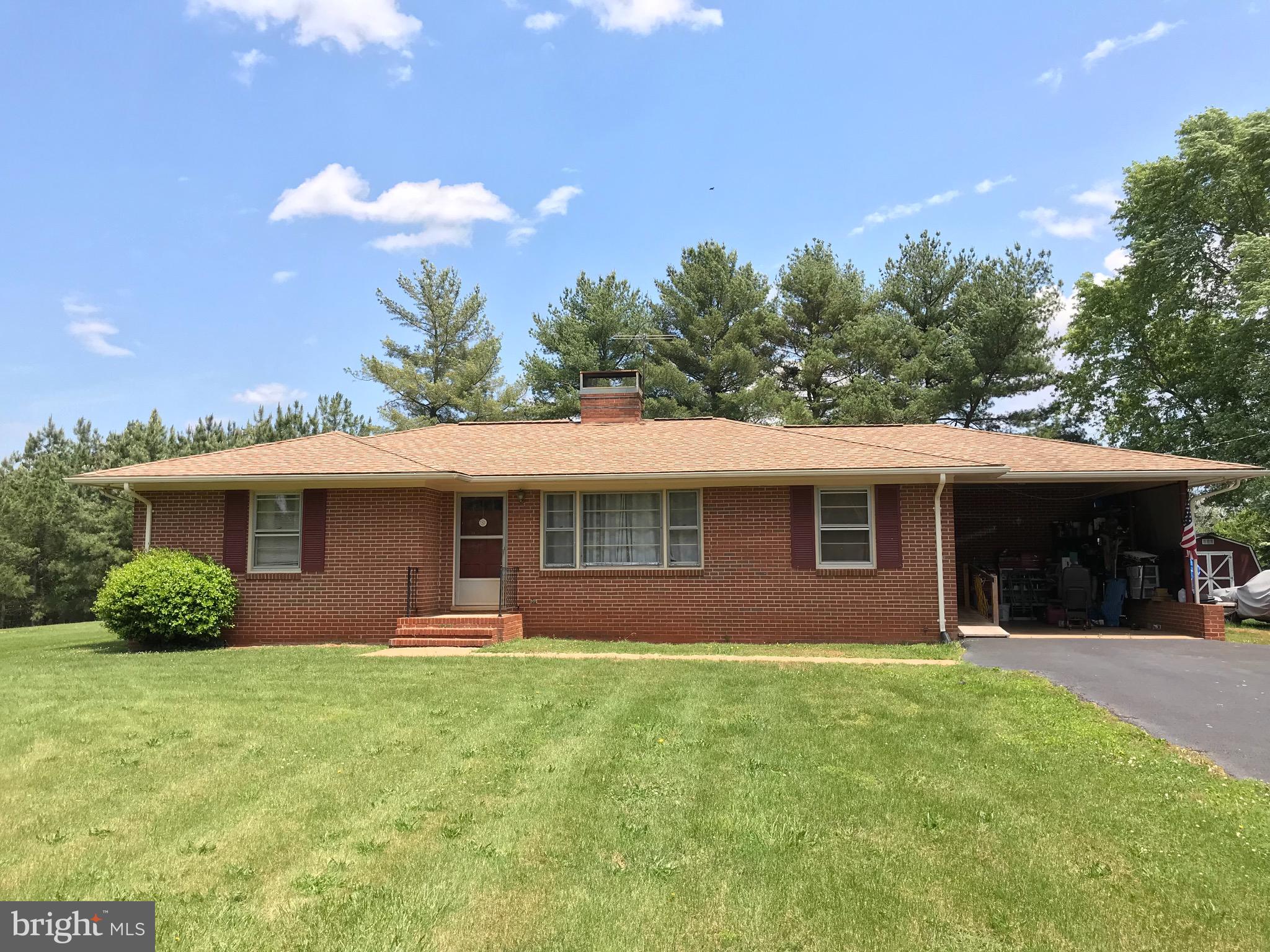 Brick rambler on large mostly level lot.