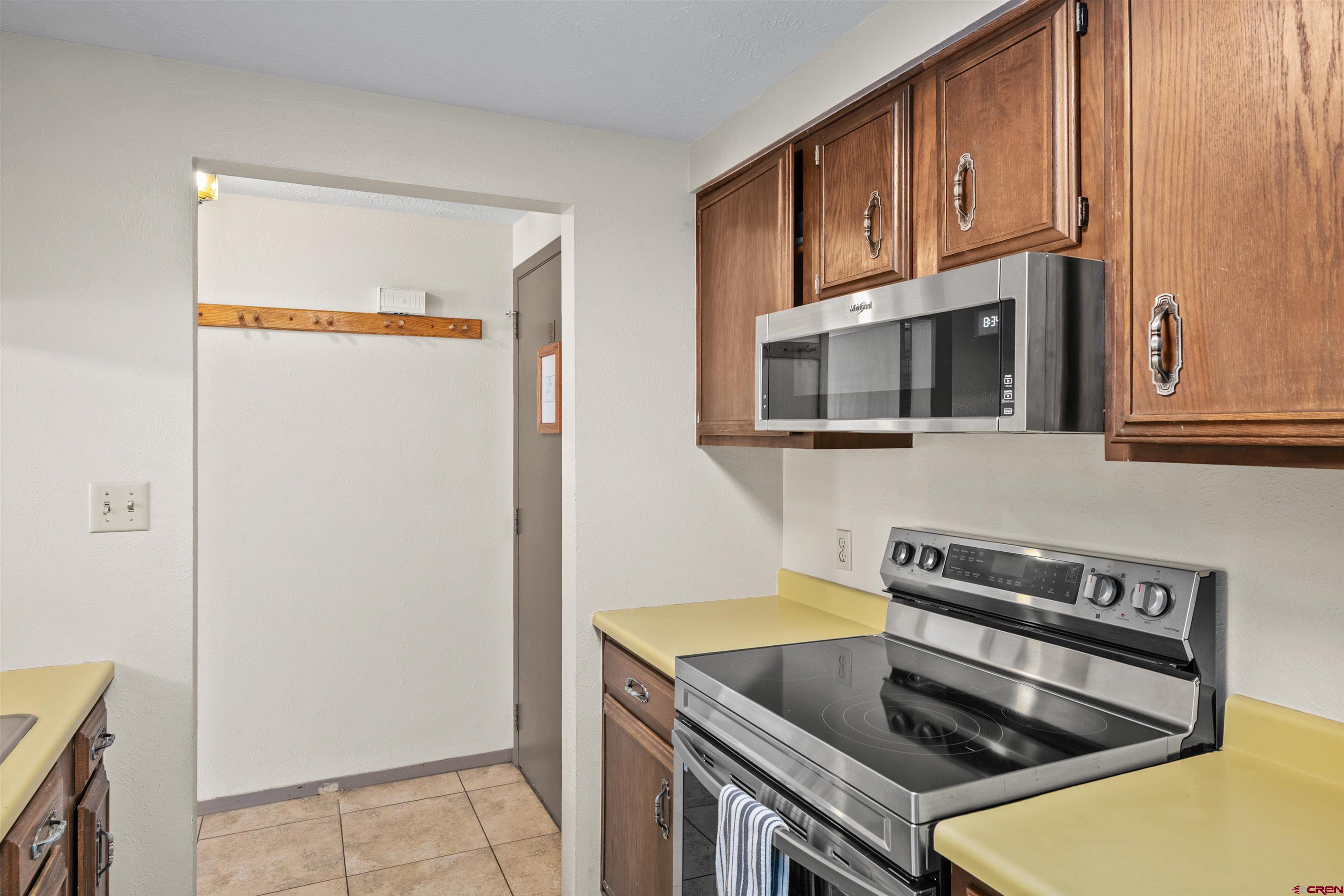 651 Gothic Road, Unit 306 Crested Butte, CO 81225 - Photo 16 of 24 a kitchen with stainless steel appliances granite countertop a stove a microwave and a sink