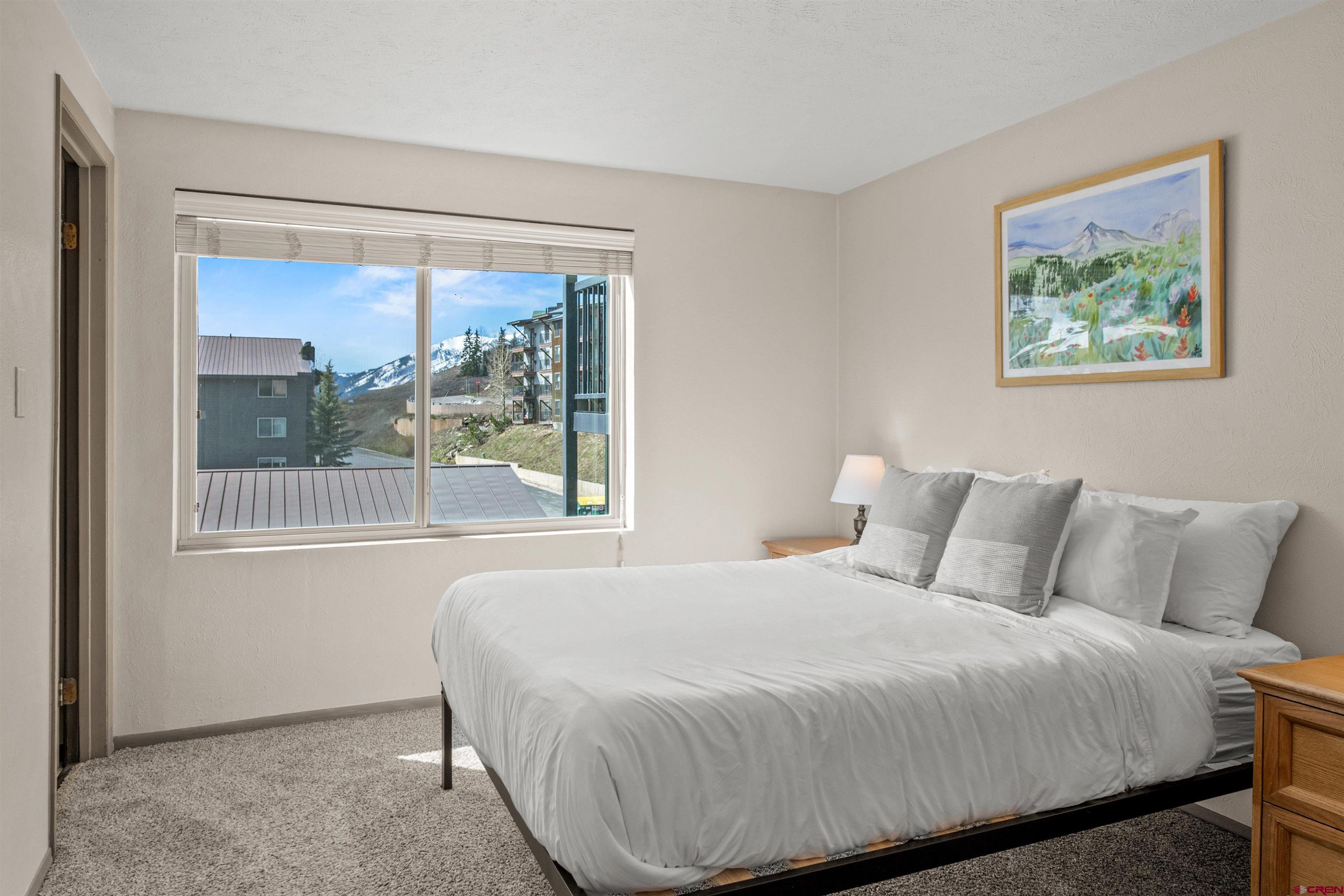 651 Gothic Road, Unit 306 Crested Butte, CO 81225 - Photo 17 of 24 a bedroom with a bed and a painting on the wall