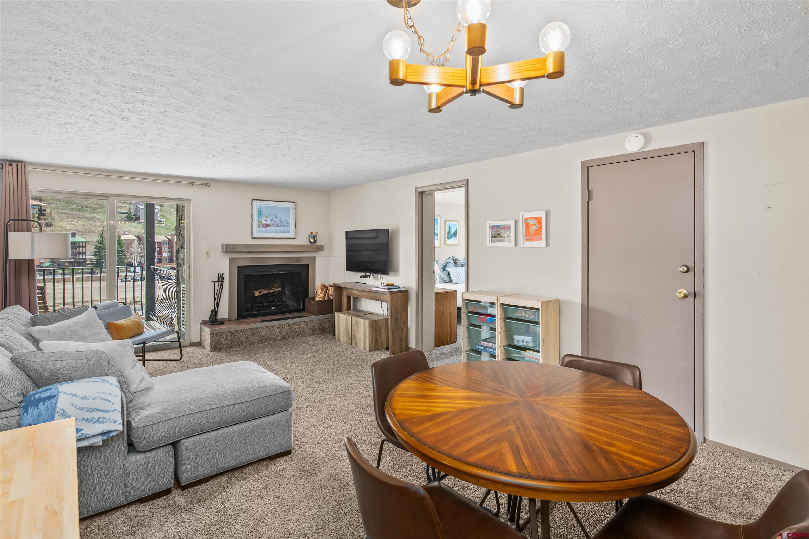 651 Gothic Road, Unit 306 Crested Butte, CO 81225 - Photo 4 of 24 a living room with furniture and a fireplace