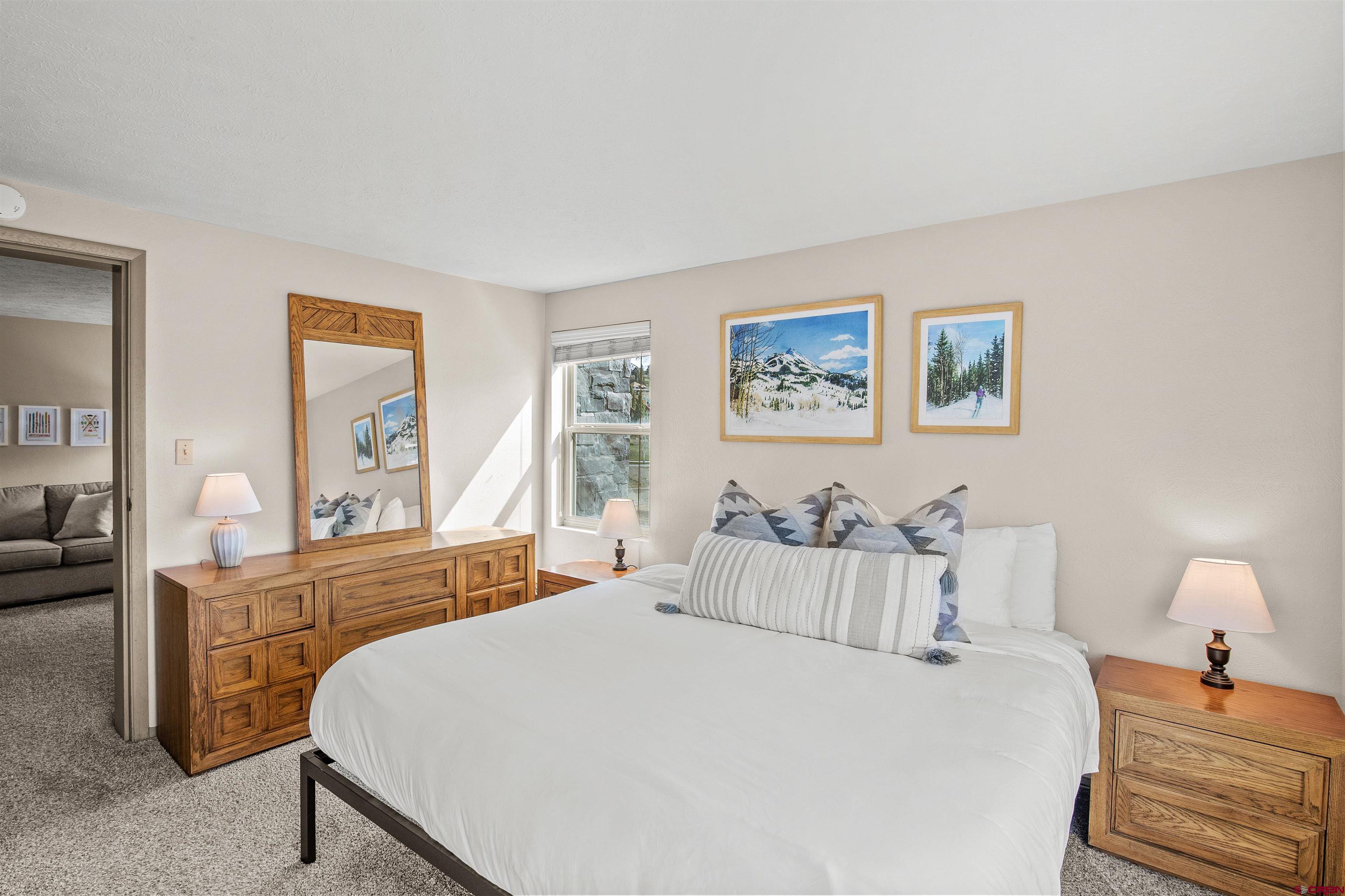 651 Gothic Road, Unit 306 Crested Butte, CO 81225 - Photo 7 of 24 a bedroom with a bed and wooden floor