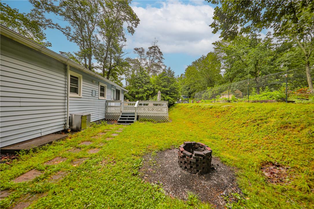 5599 Minks Pond Road Bushkill, PA 18324 - Photo 47 of 64 A spacious backyard with a private deck, perfect for outdoor gatherings and relaxation.