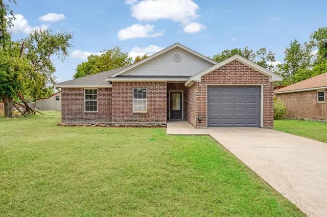 a view of a house with a yard and garage
