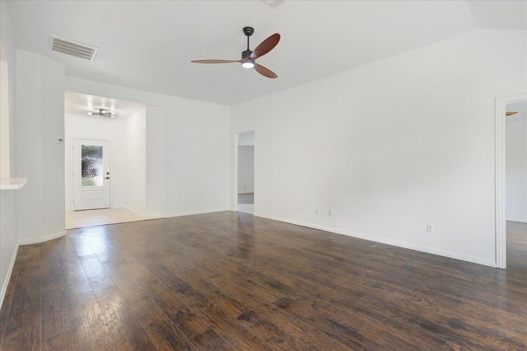 700 East 6th Street Bonham, TX 75418 - Photo 12 of 28 a view of empty room with wooden floor and ceiling fan