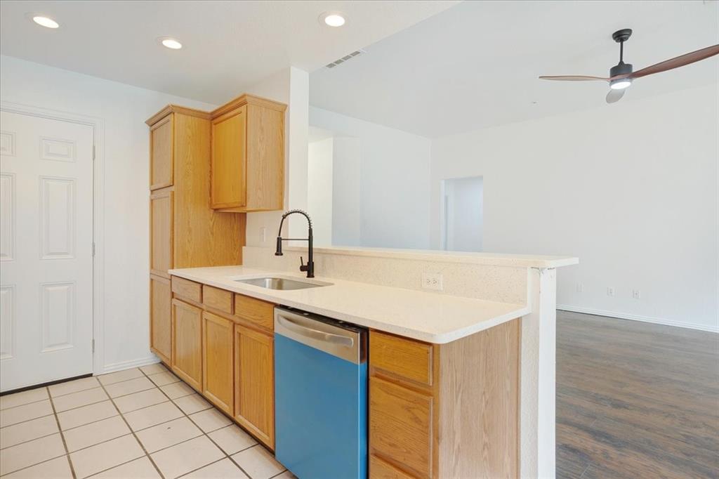 700 East 6th Street Bonham, TX 75418 - Photo 14 of 28 a kitchen with a sink cabinets and wooden floor