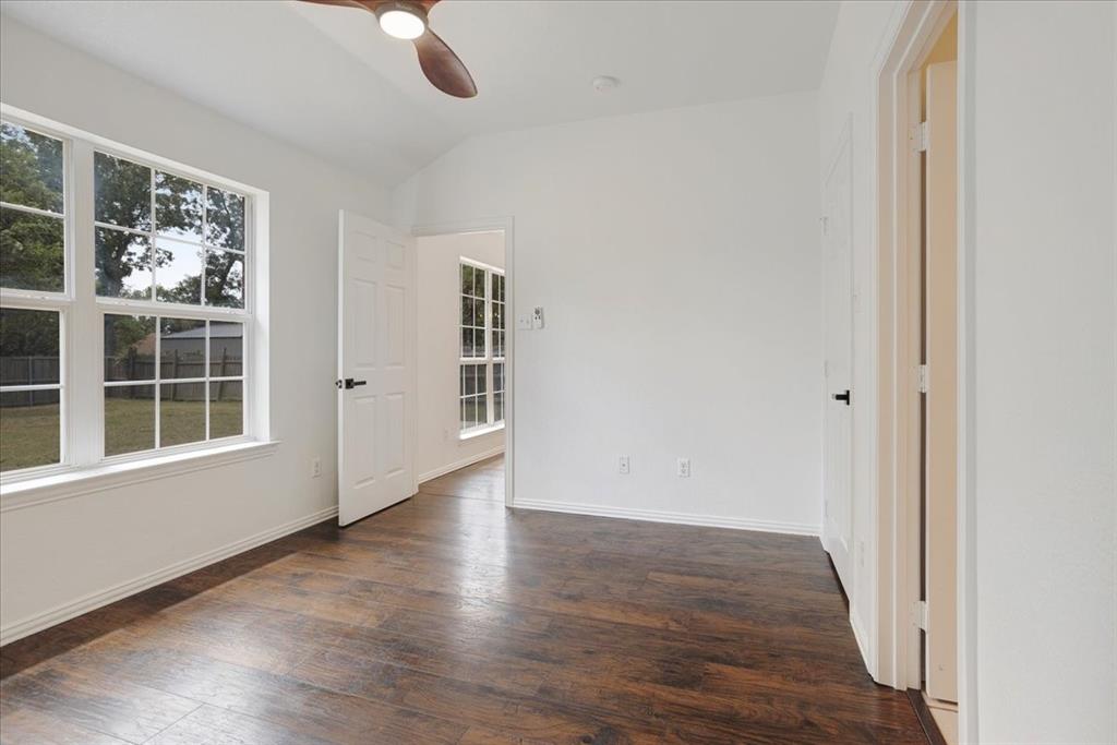 700 East 6th Street Bonham, TX 75418 - Photo 18 of 28 wooden floor in an empty room with a window