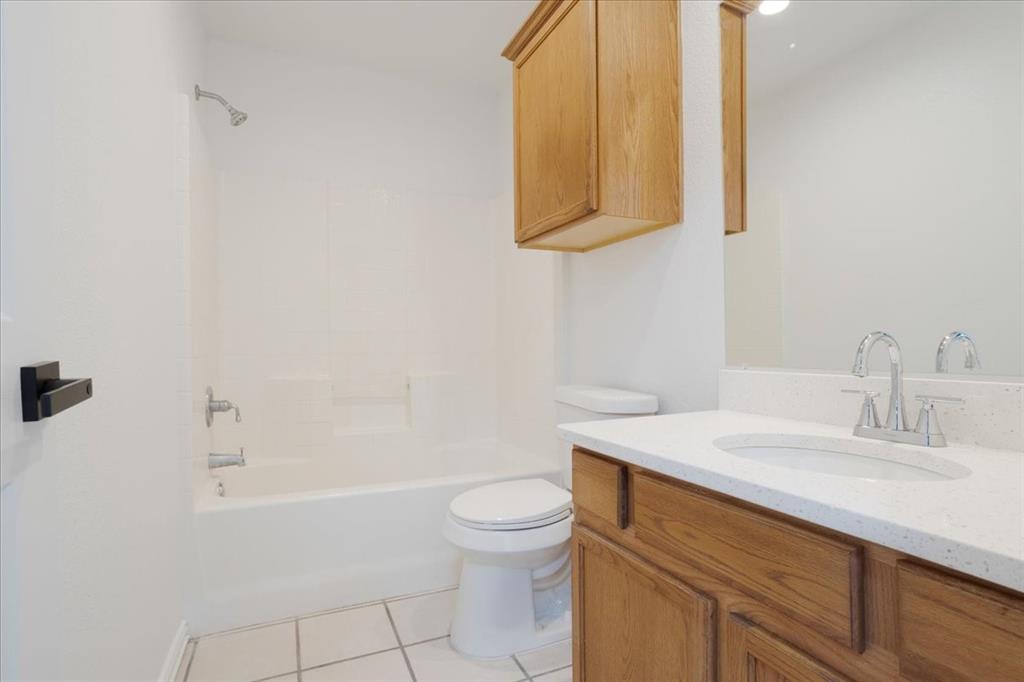 700 East 6th Street Bonham, TX 75418 - Photo 24 of 28 a bathroom with a sink a toilet and shower