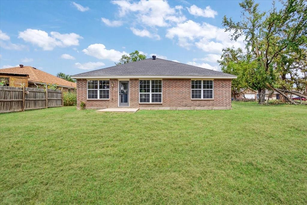 700 East 6th Street Bonham, TX 75418 - Photo 6 of 28 a front view of a house with a garden