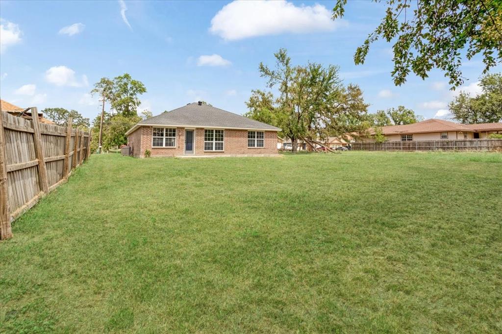 700 East 6th Street Bonham, TX 75418 - Photo 7 of 28 a front view of a house with a garden