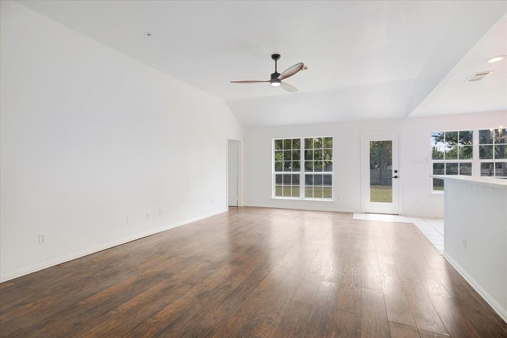 700 East 6th Street Bonham, TX 75418 - Photo 9 of 28 wooden floor in an empty room with a window