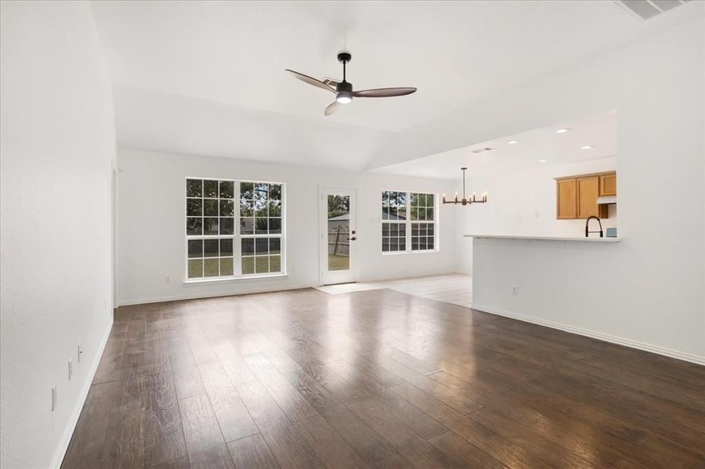 700 East 6th Street Bonham, TX 75418 - Photo 10 of 28 a view of an empty room with wooden floor and a window