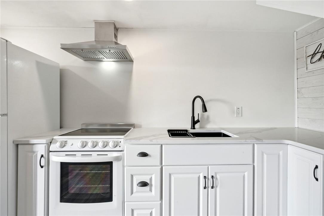 463 North Penn Dixie Road Bath, PA 18014 - Photo 41 of 86 A well-appointed kitchen features a modern range hood, contemporary sink, and ample white cabinetry.