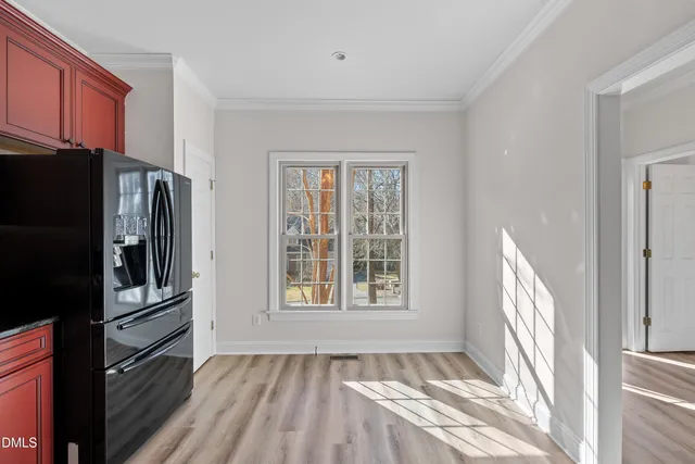 a view of a kitchen with a refrigerator cabinets a sink and dishwasher