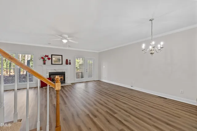 a view of a livingroom with wooden floor and stairs