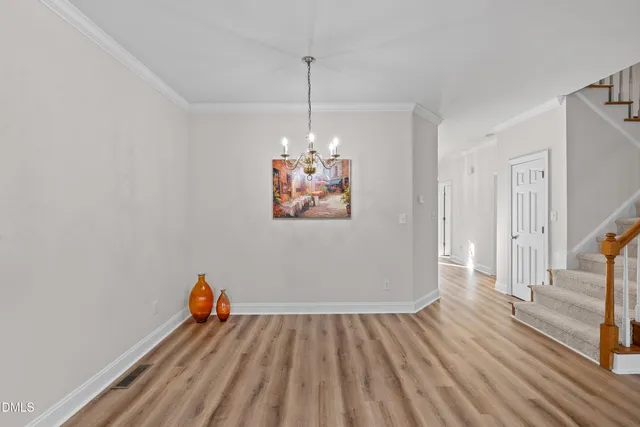 a view of a room with wooden floor and window