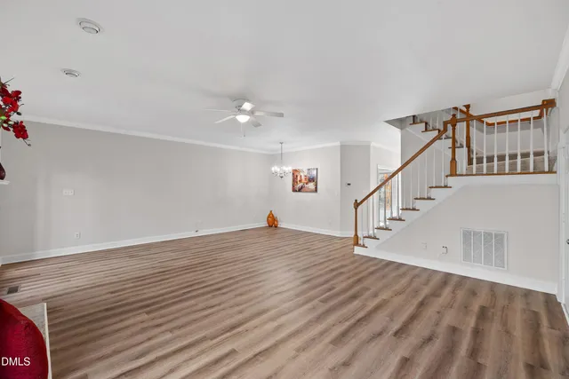 a view of entryway and hall with wooden floor