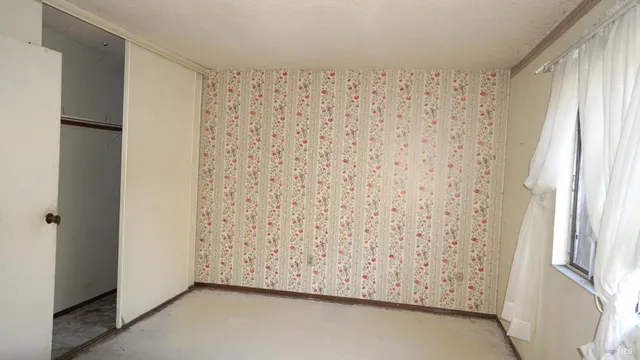 a view of staircase with white walls and a window