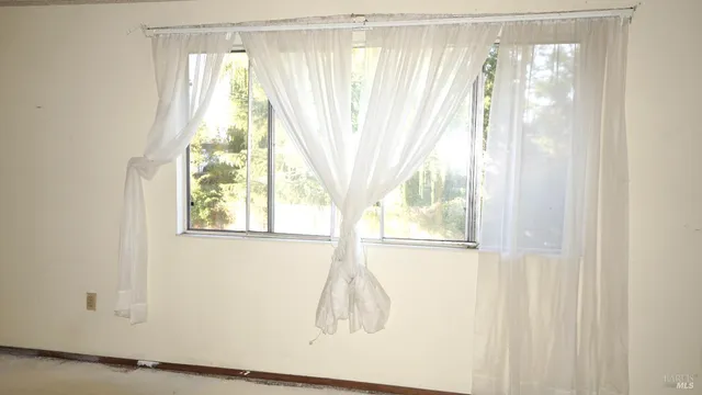 a bathroom with a toilet and a shower curtain
