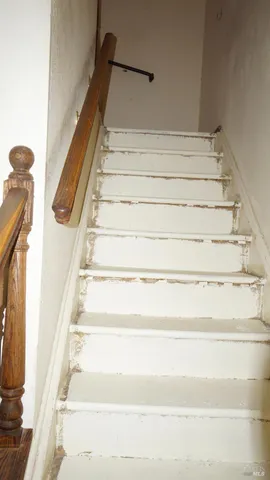 a table and chairs in front of flowers
