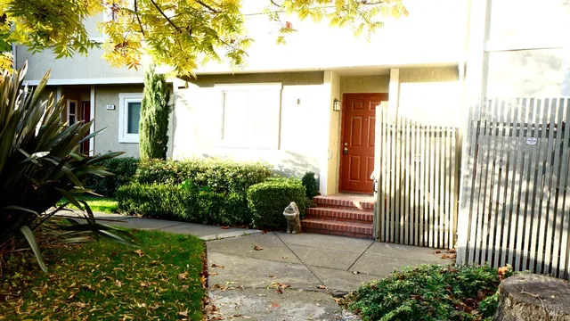 a front view of a house with a garden