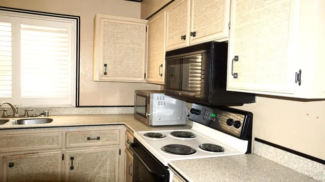a kitchen with a sink cabinets and appliances
