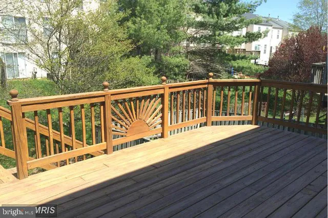 a view of balcony with wooden floor and fence