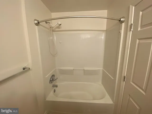 a bathroom with a shower and a bath tub