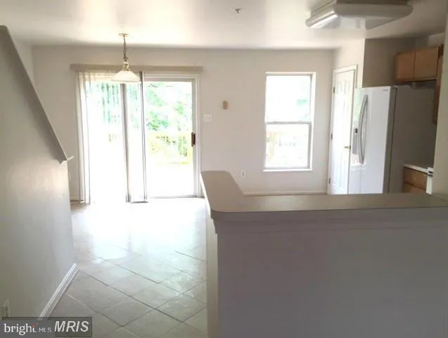 a kitchen with windows and refrigerator