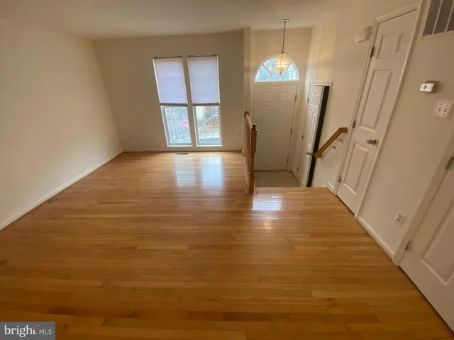 a view of a room with wooden floor and staircase