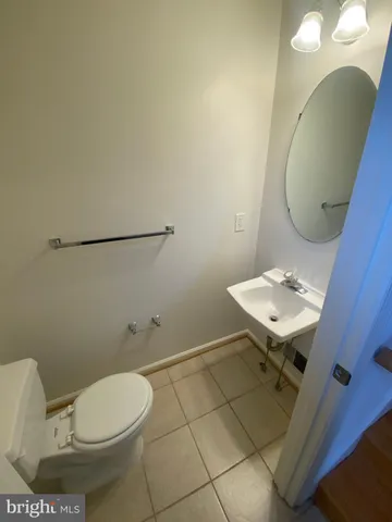 a bathroom with a sink toilet and a mirror