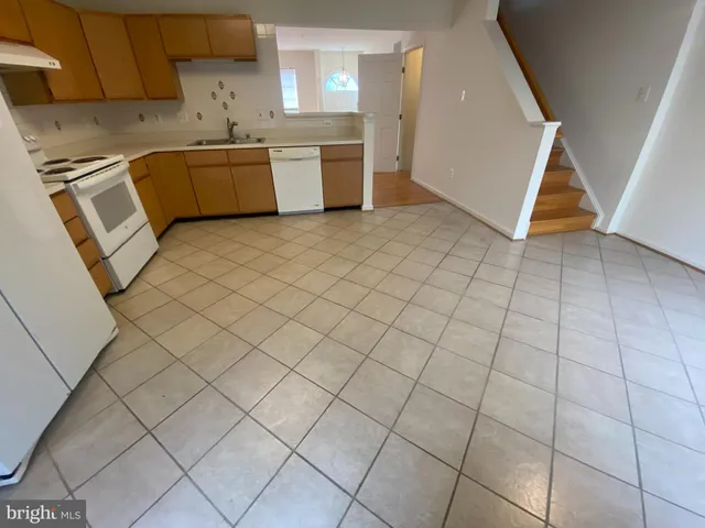 a utility room with cabinets washer and dryer