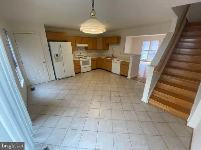 a view of a kitchen with a sink and a refrigerator