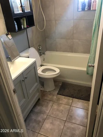 a bathroom with a toilet and a bathtub