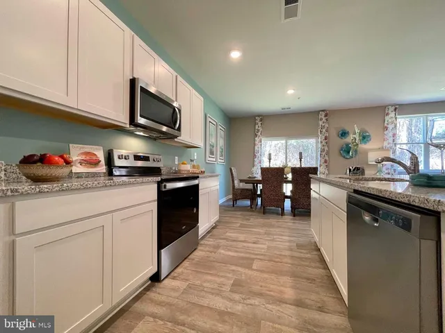 a kitchen with stainless steel appliances granite countertop lots of counter top space