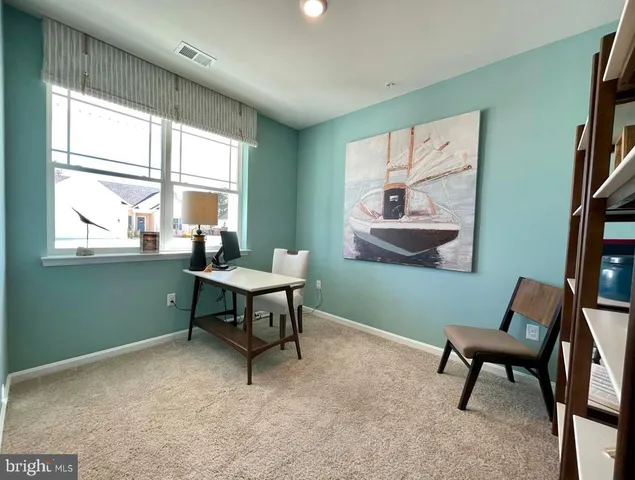 a work room with furniture and a window