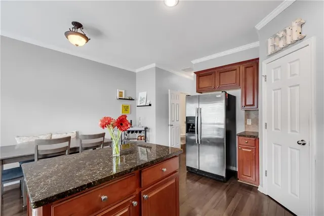 a kitchen with stainless steel appliances granite countertop a refrigerator and a sink