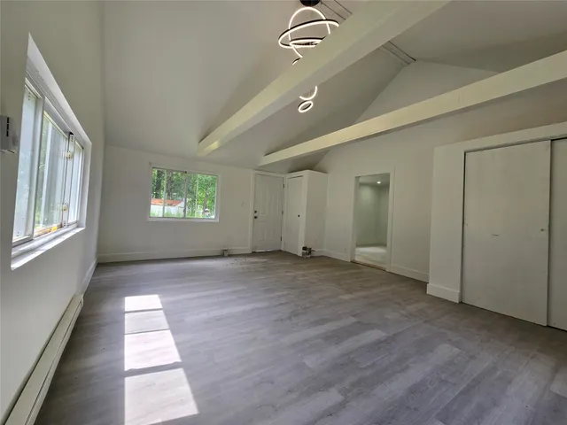 a view of an empty room and a window