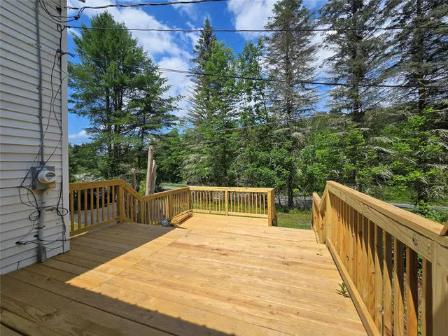 a view of balcony with wooden floor and fence