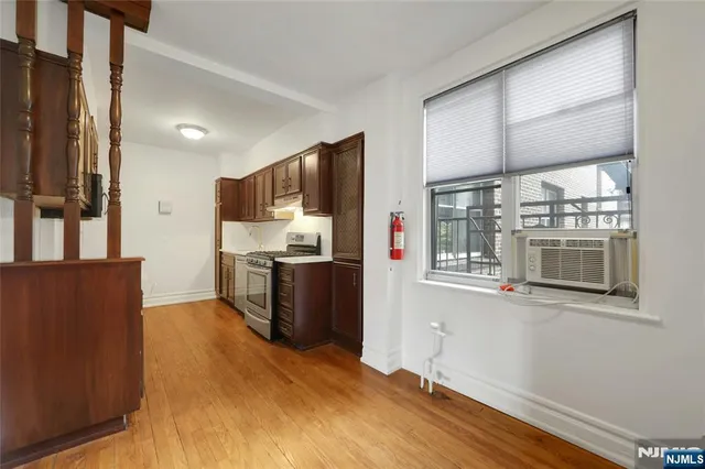 a kitchen with stainless steel appliances kitchen island granite countertop a refrigerator and a stove top oven