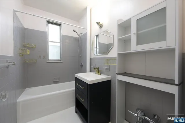 a bathroom with a sink a bathtub and a shower