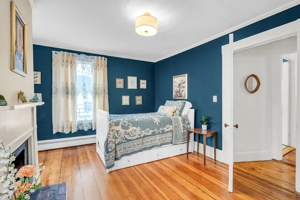 a living room with a bed furniture and a large window