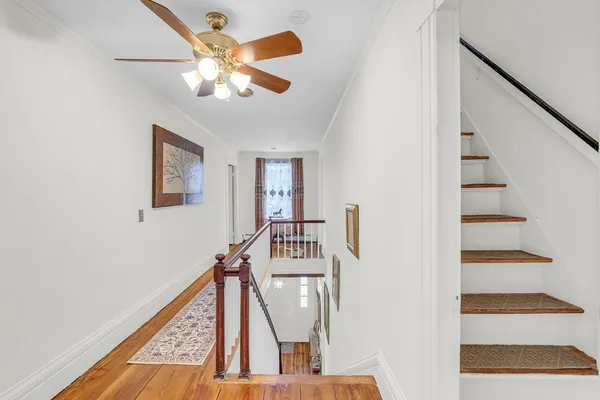 a view of entryway and hall with wooden floor