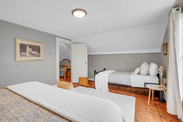 a bedroom with a bed and a lamp