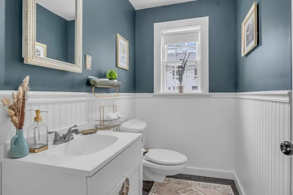 a bathroom with a sink a toilet and mirror